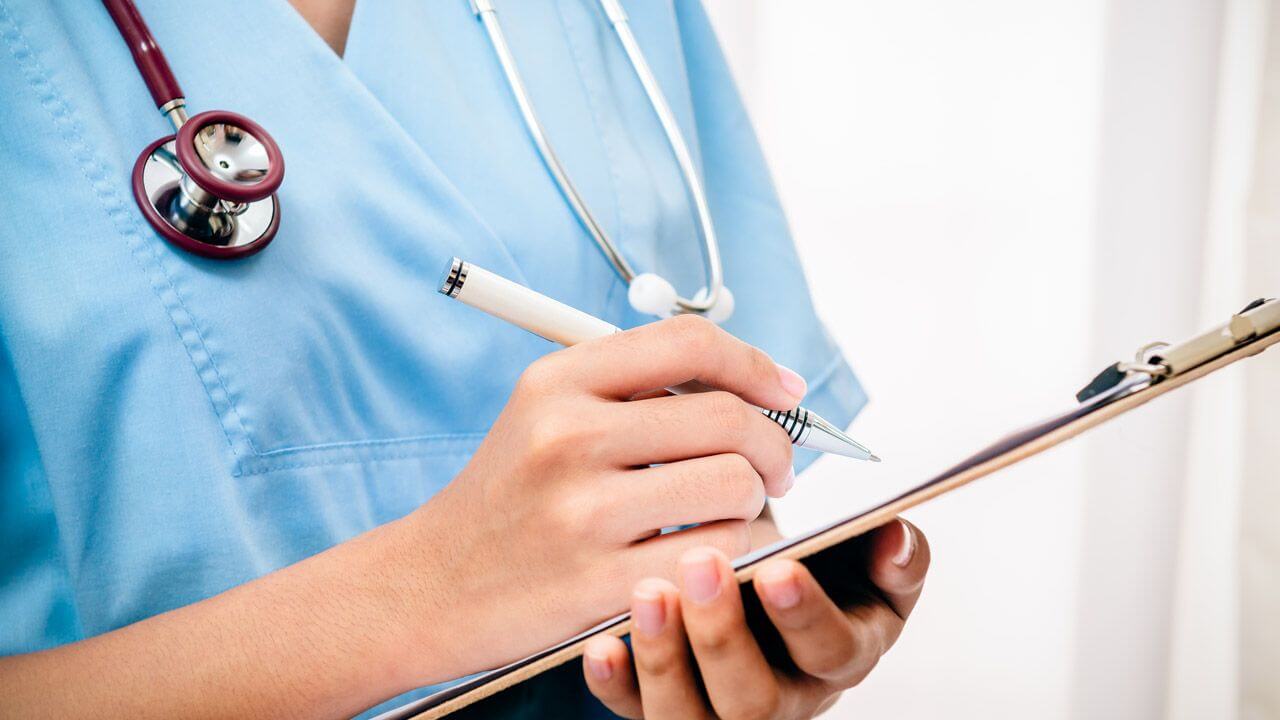 Nurse making notes on a clipboard