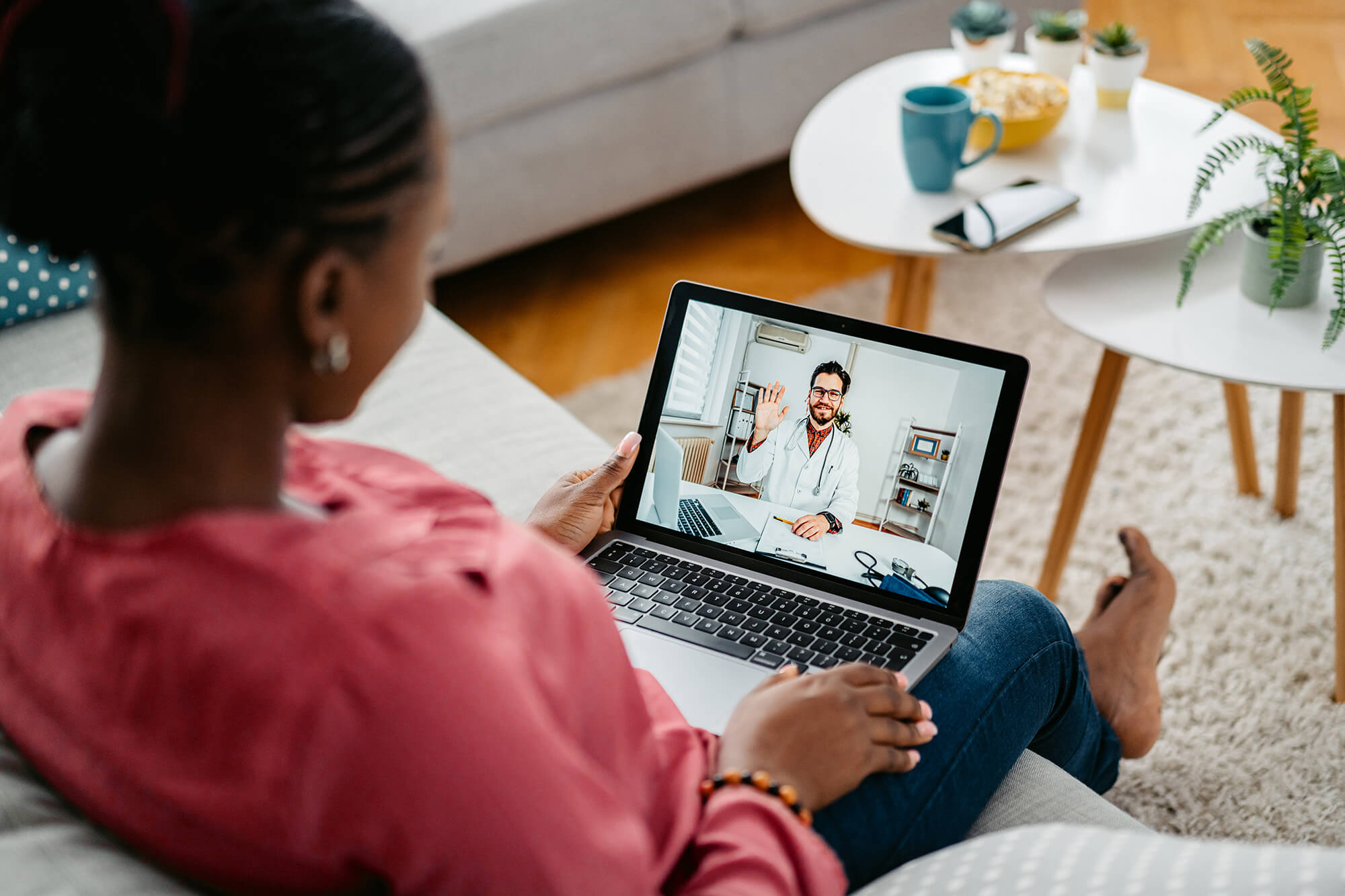 Woman talking with doctor virtually on laptop